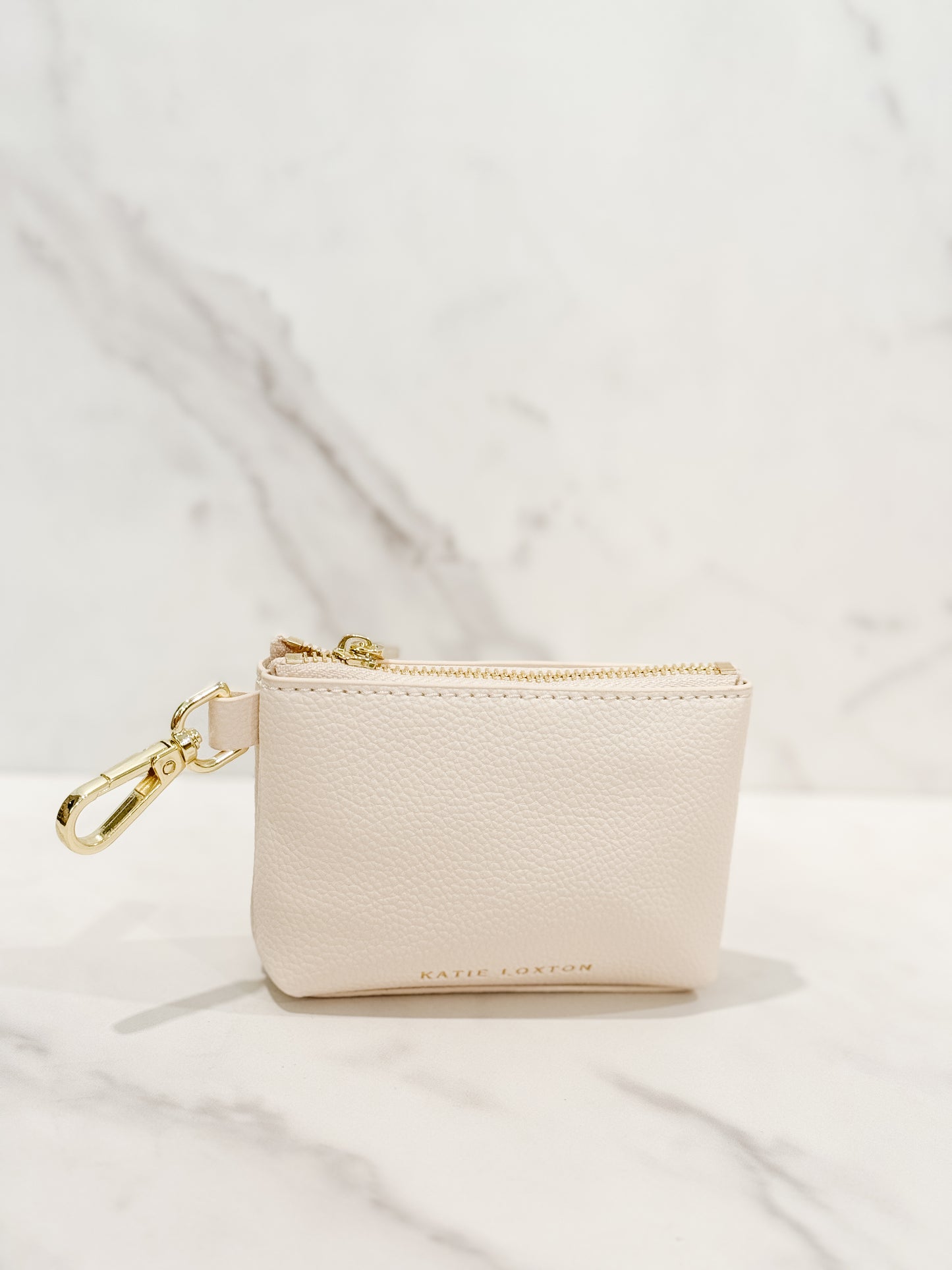 Katie loxton Evie clip-on coin purse in eggshell, small and compact design with gold clasp, perfect for keeping coins, cash, and essentials organized.