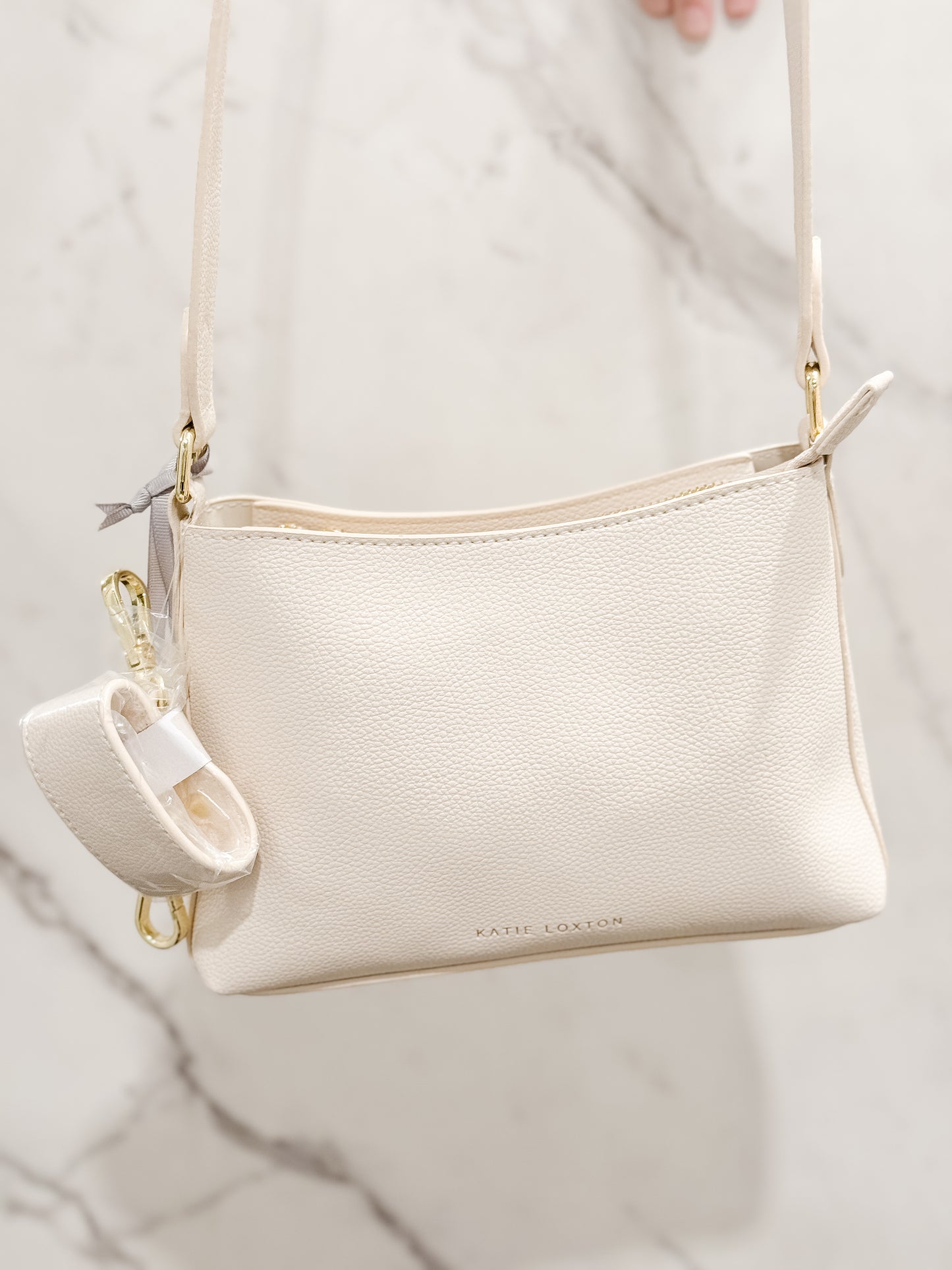 Katie Loxton Evie Crossbody bag made of vegan leather with a gold accents in the color eggshell