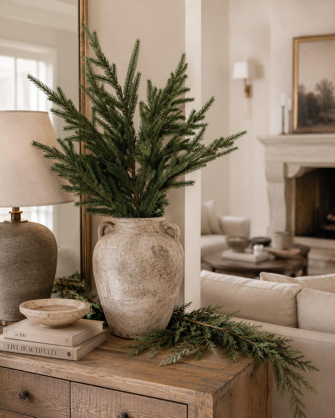29-inch real touch Norfolk pine stem arranged in a stoneware vase in a neutral living room with organic holiday décor.
