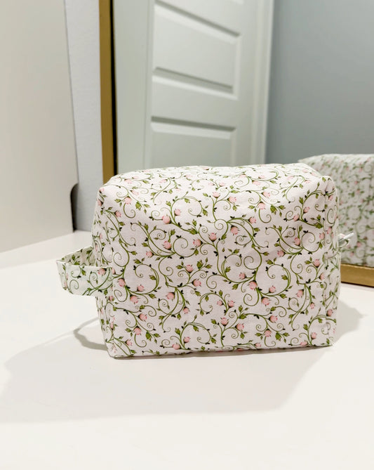 Handmade quilted makeup bag with pink rosebud and vine print
