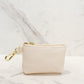 Evie clip-on coin purse in eggshell, small and compact design with gold clasp, perfect for keeping coins, cash, and essentials organized.