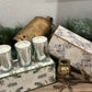 Elegant Evergreen Glow Candle Trio in frosted glass with hand-painted decorative box featuring gold foil accents.