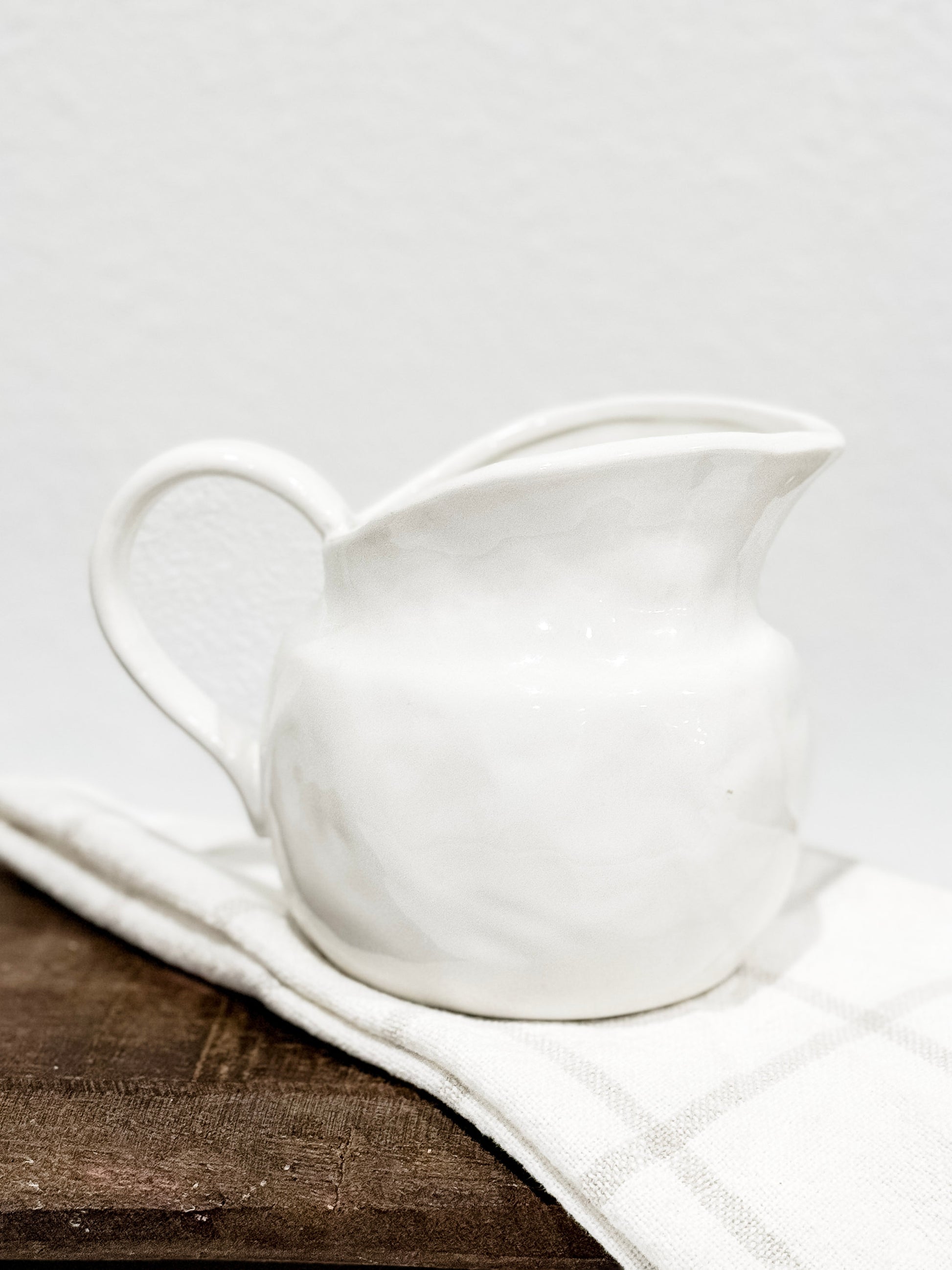Stoneware creamer pitcher with smooth glazed finish