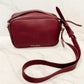 Enjoy our vegan leather crossbody bags that support college team colors and take you right into fall with navy blue, maroon, sage green, beige, and white