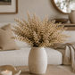 Cream faux astilbe stem displayed against a white marble studio backdrop, highlighting its realistic texture and soft neutral color 2 stems.
