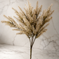 Cream faux astilbe stem displayed against a white marble studio backdrop, highlighting its realistic texture and soft neutral color.