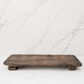 Minimal rustic decorative wood board photographed on a clean marble surface with neutral studio styling and no dramatic shadows.