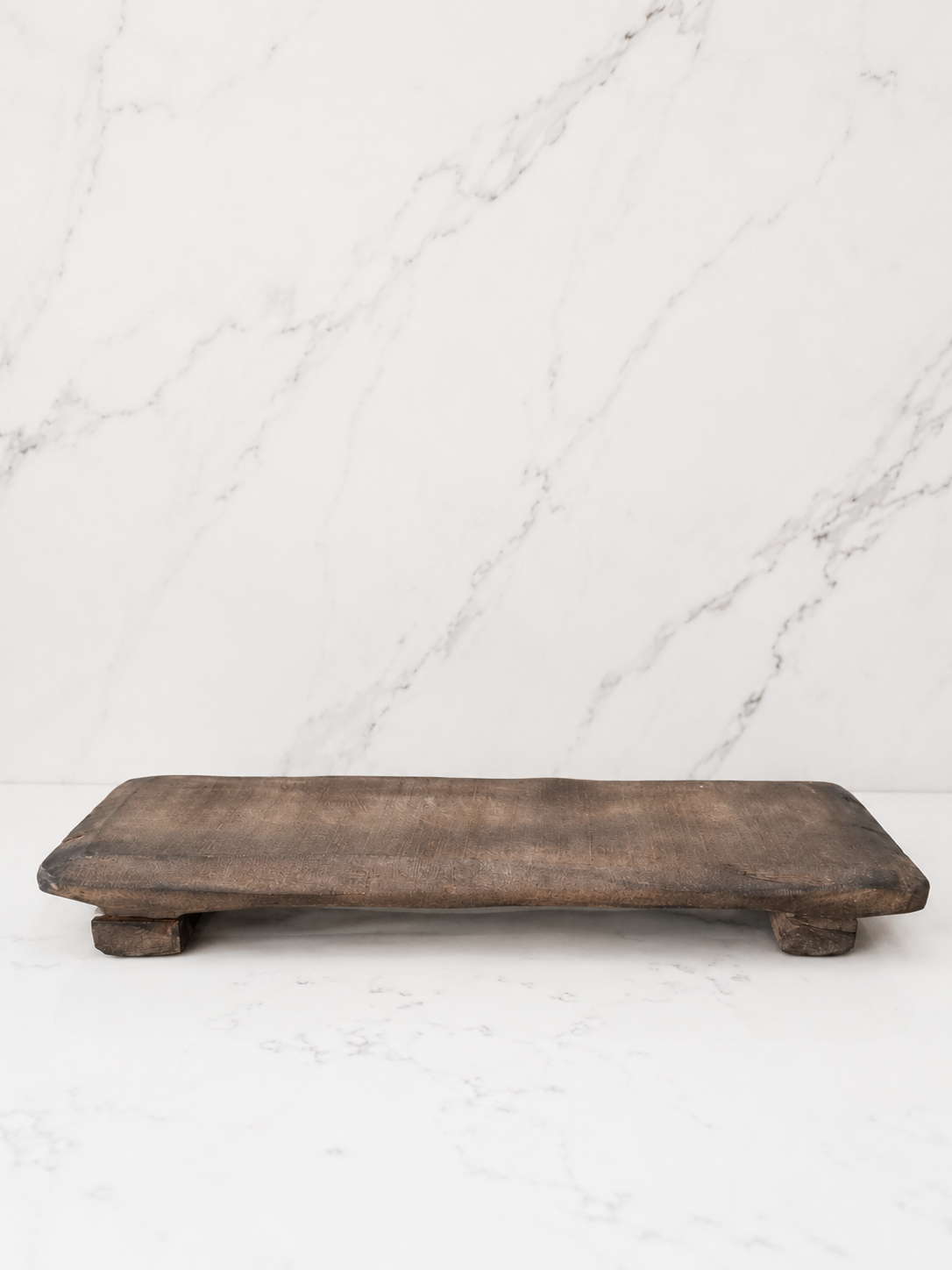 Minimal rustic decorative wood board photographed on a clean marble surface with neutral studio styling and no dramatic shadows.