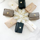 Evie Clip On AirPoad Cases circled around on a marble counterop displaying all the colors.