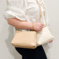 Evie Crossbody Bag in Soft Tan and Eggshell with adjustable strap, perfect for casual and formal outfits.