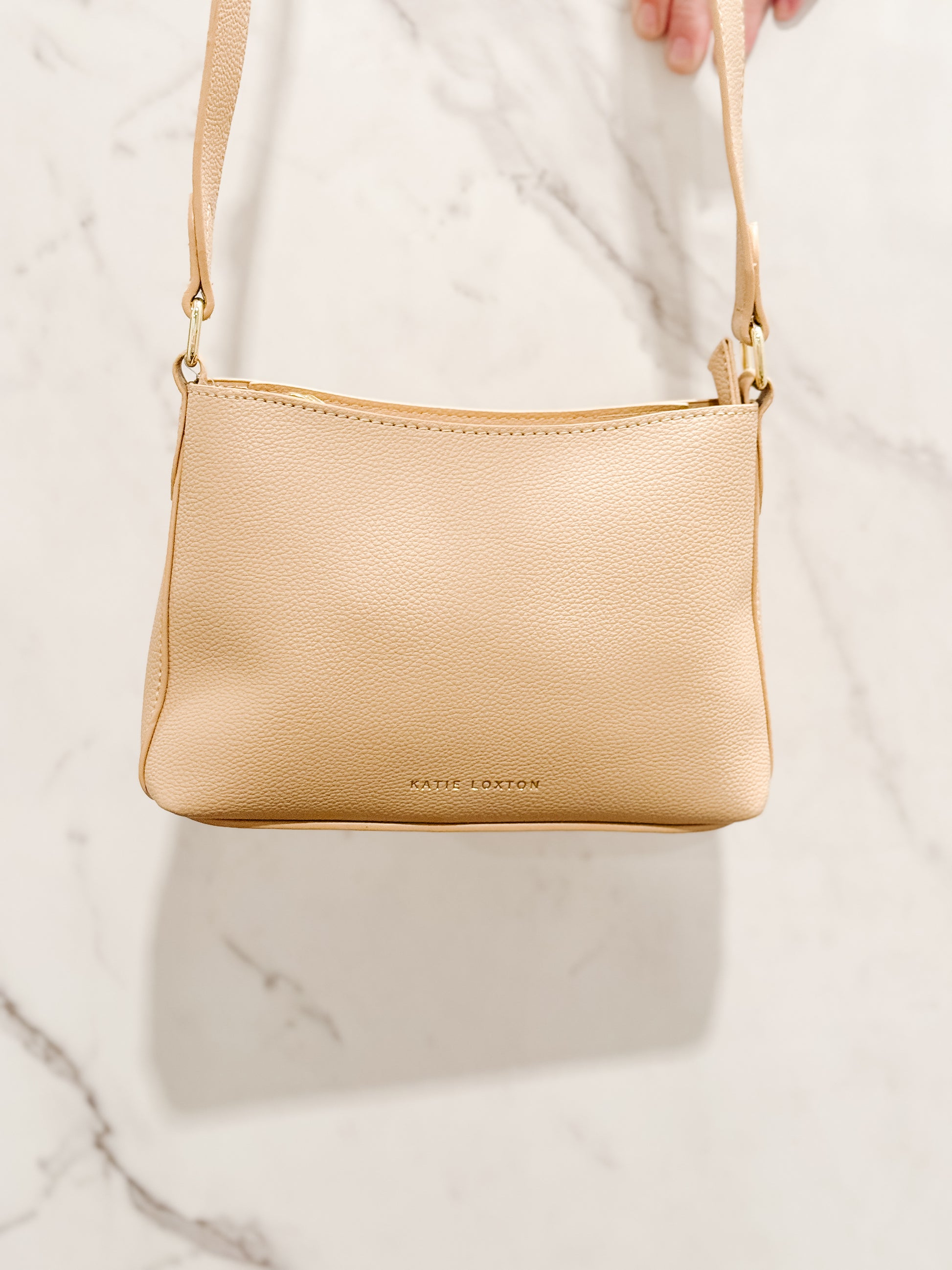 Front vie of the Evie Crossbody bag in soft tan