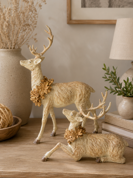 Resin faux wood grain deer with an antique gold wreath styled on a neutral Christmas console table.