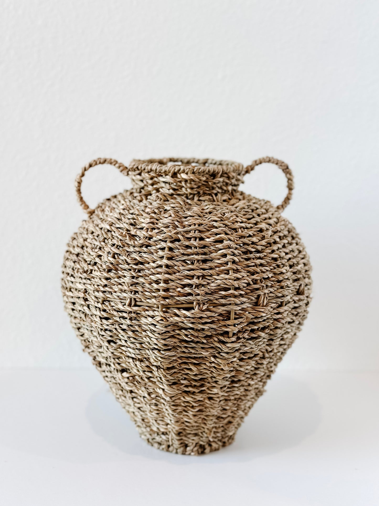 Handwoven seagrass vase with two handles
