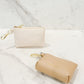 Evie clip-on coin purse in soft tan and eggshell, small and compact design with gold clasp, perfect for keeping coins, cash, and essentials organized.