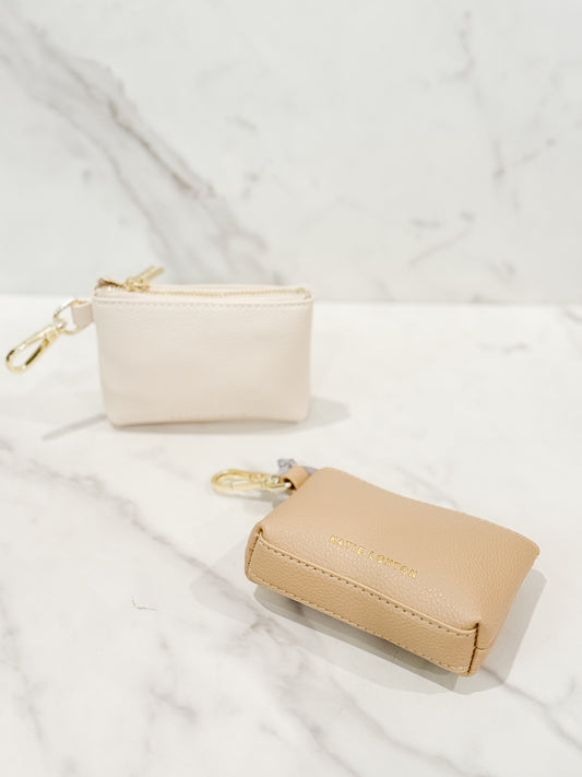 Evie clip-on coin purse in soft tan and eggshell, small and compact design with gold clasp, perfect for keeping coins, cash, and essentials organized.