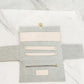 Showcasing the inside of our Katie Loxton vegan leather jewelry travel pouch in color eggshell