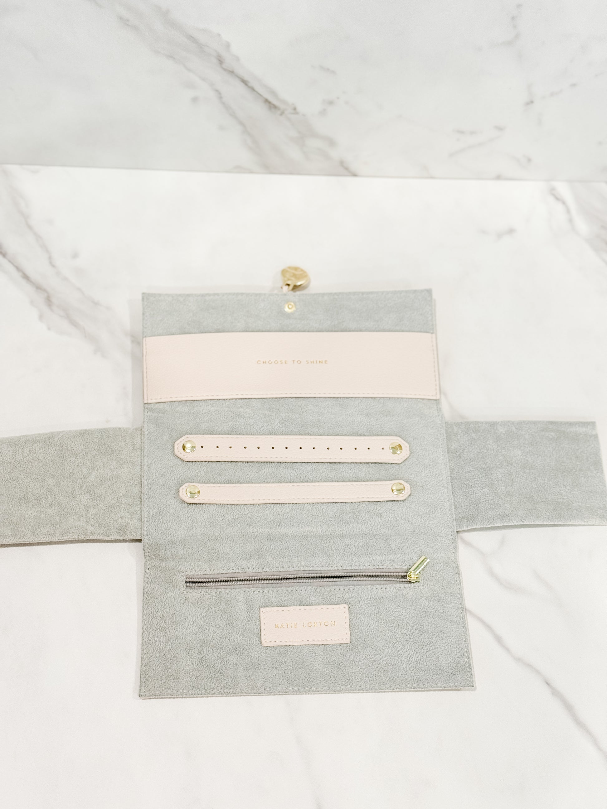 Showcasing the inside of our Katie Loxton vegan leather jewelry travel pouch in color eggshell