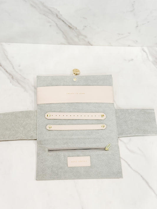 Showcasing the inside of our Katie Loxton vegan leather jewelry travel pouch in color eggshell