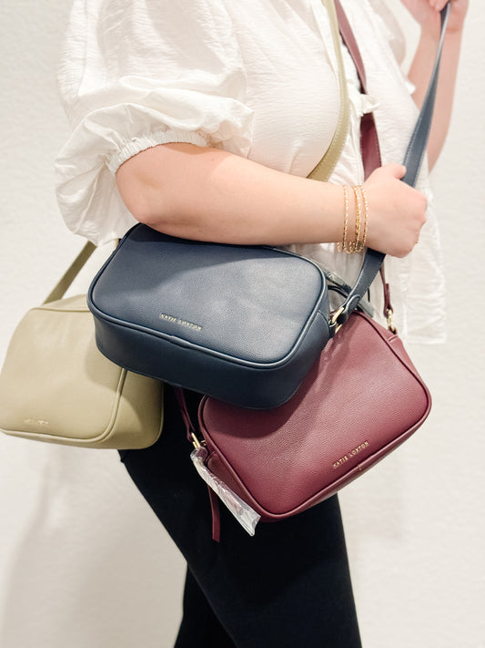 Katie Loxton vegan leather crossbody bag fall colors in navy blue, sage green and maroon, crimson.
