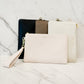 Katie Loxton Zana wristlet pouch in a vegan leather with gold zip featuring the colors mink, eggshell, black and cream