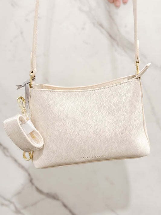 Katie Loxton Evie Crossbody bag made of vegan leather with a gold accents in the color eggshell