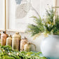 Real Touch Norfolk Pine garland styled on mantel with gold bells and winter greenery