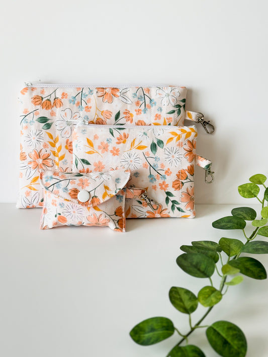 Set of handmade floral pocuhes from the Peach Blossom Meadow Collection including our peach blossom meadow  zipper pouch, coin purse and airpod case