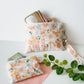 Medium handmade Peach Blossom Meadow floral zipper pouch styled with our peach blossom coin purse