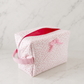 Pink floral boxy makeup bag on marble background in soft editorial studio lighting