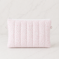 Pink floral quilted zipper pouch on soft white marble background in luxury studio lighting