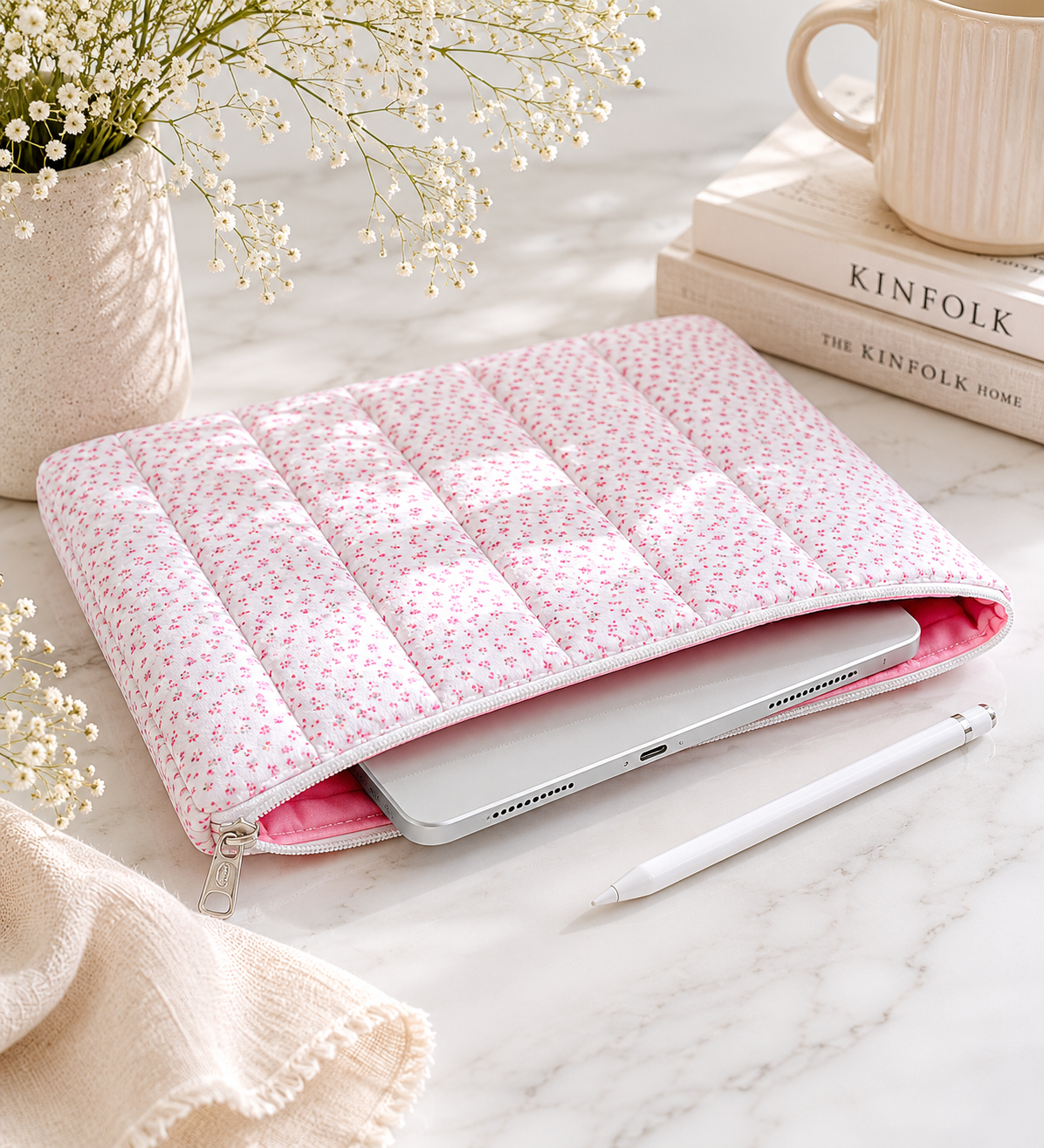 Pink floral quilted iPad sleeve styled on marble desk with tablet, neutral decor, and feminine workspace accessories