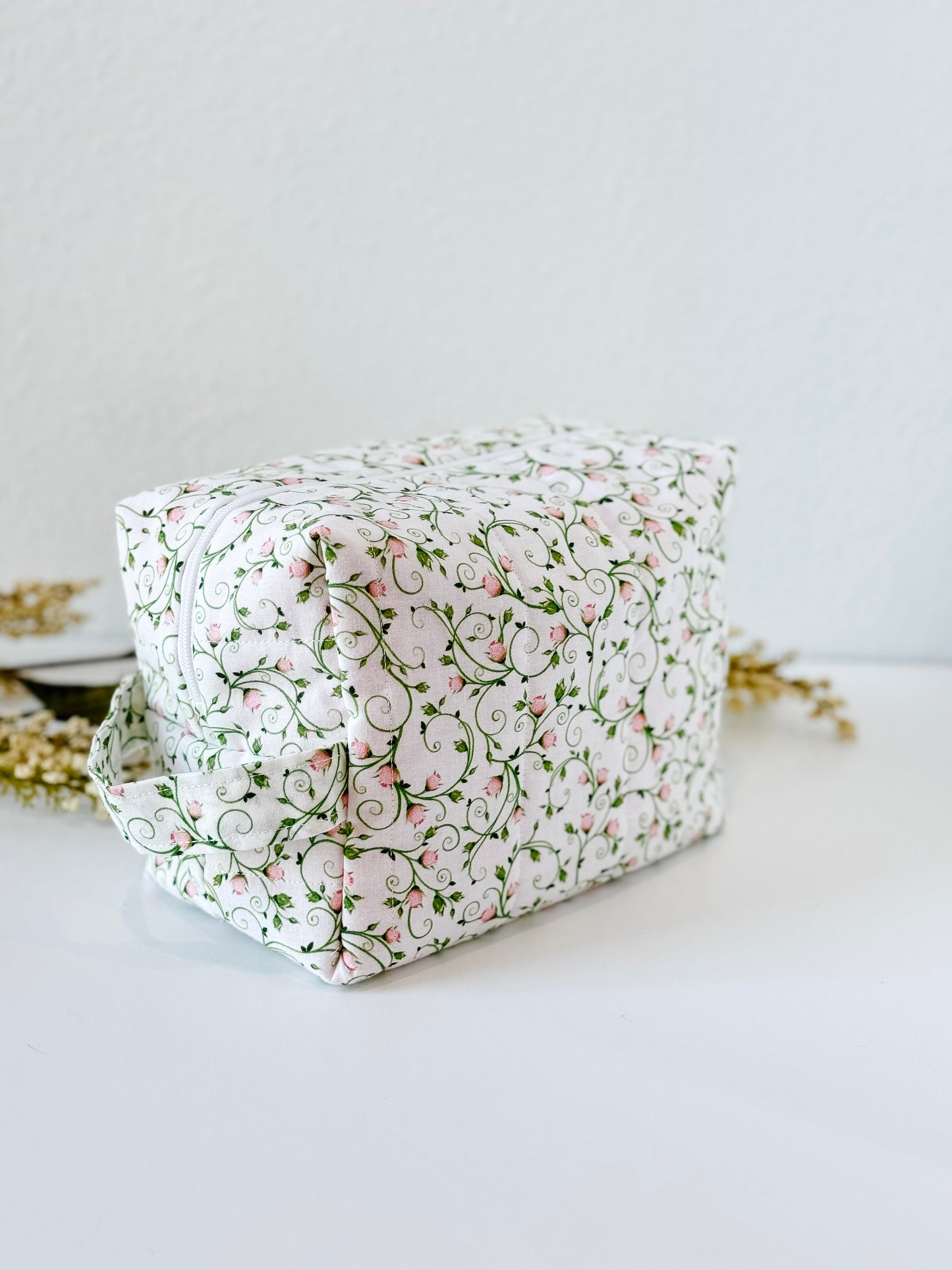 Handmade quilted makeup bag with pink rosebud and vine print