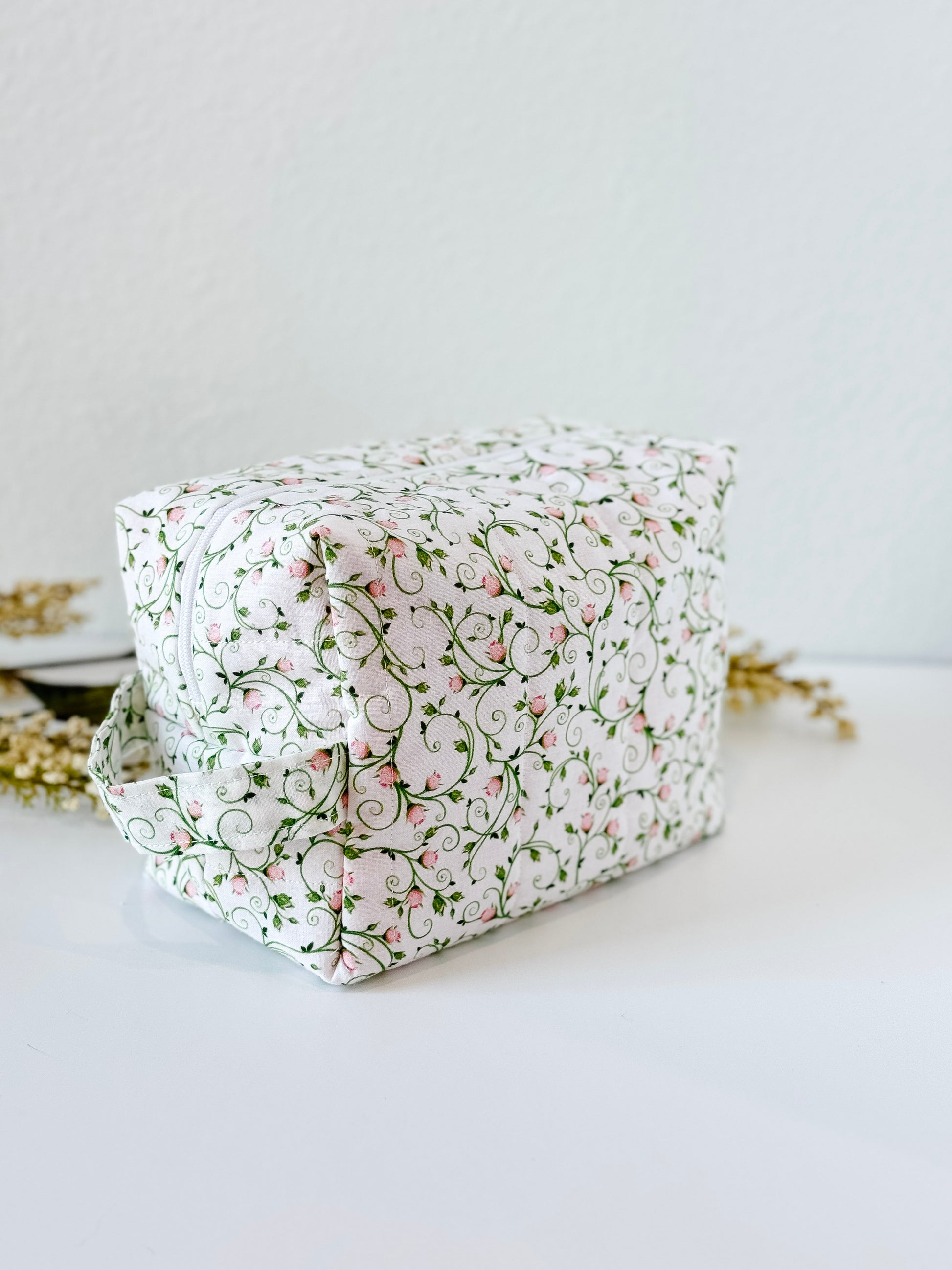 Handmade quilted makeup bag with pink rosebud and vine print