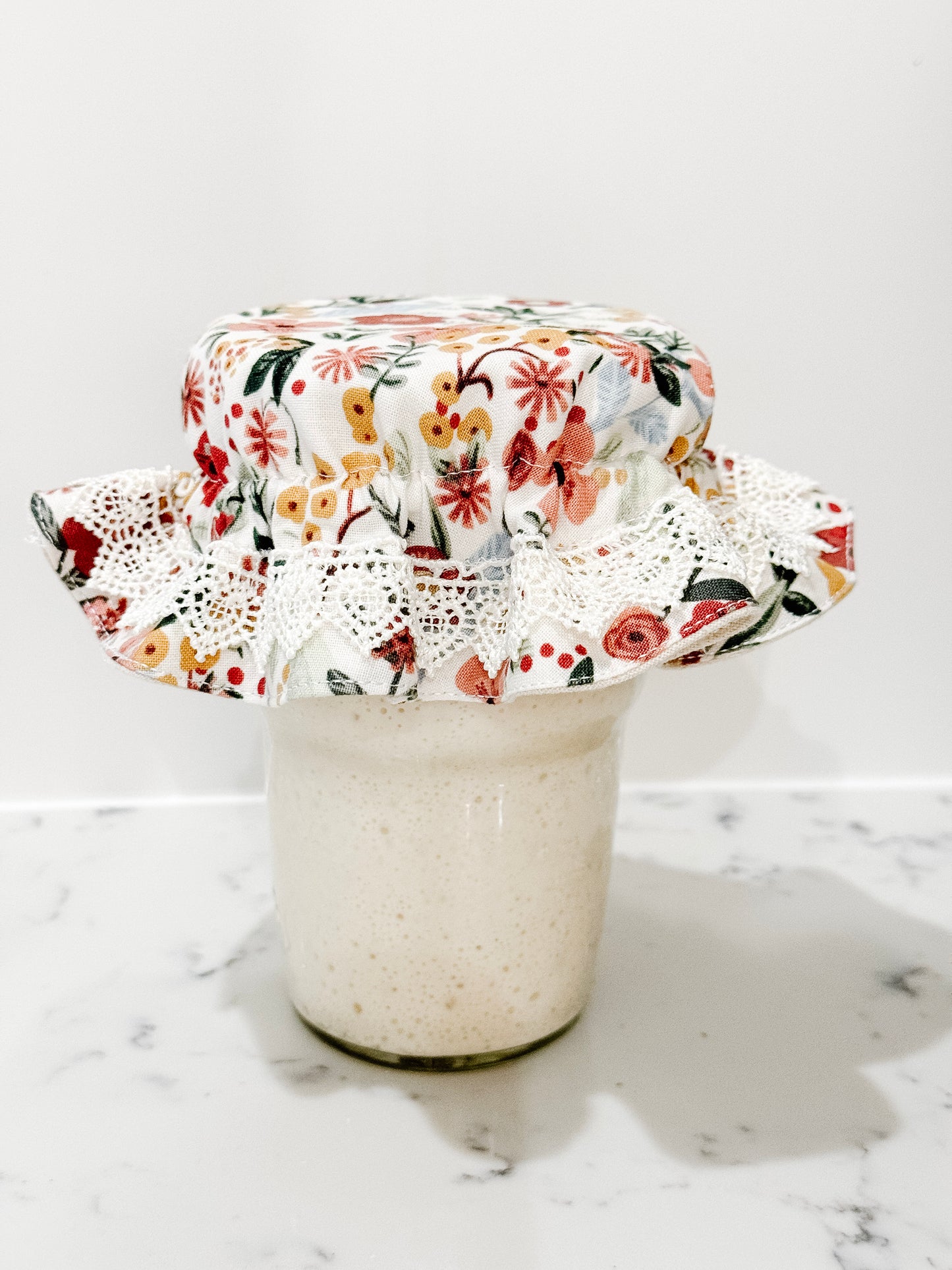 Fabric jar cover for sourdough starter on mason jar