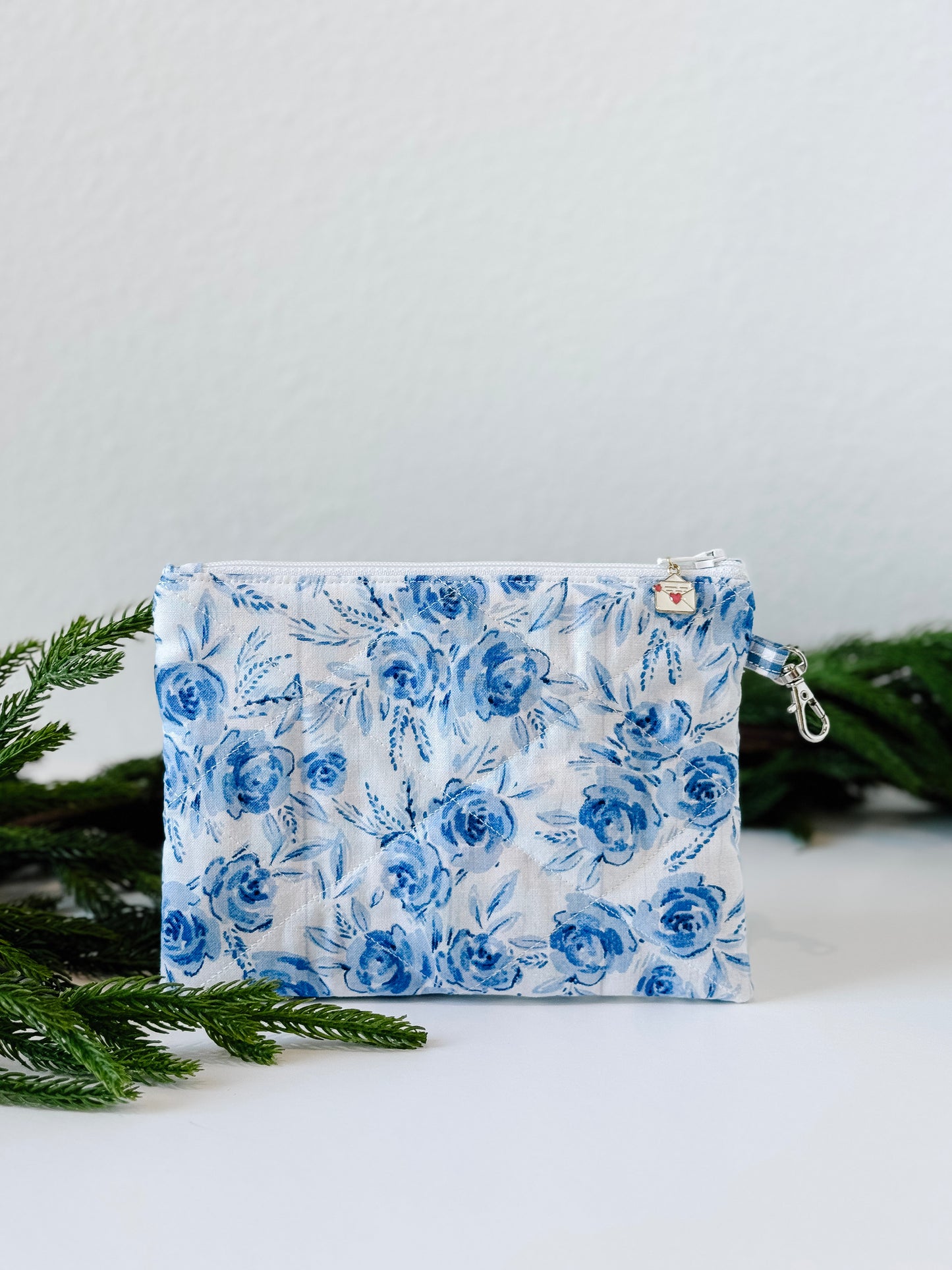 Small floral quilted wristlet pouch with blue gingham lining