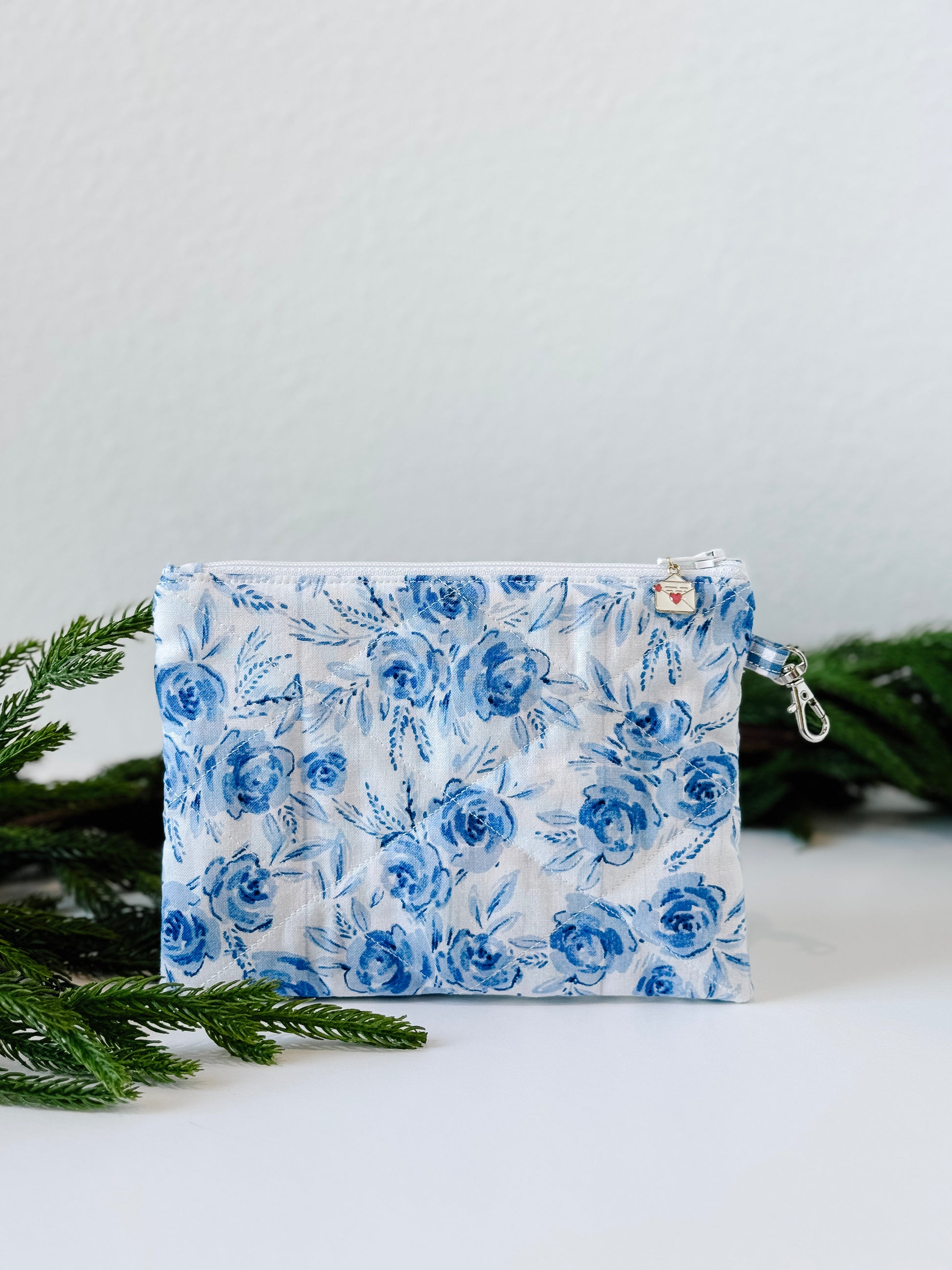 Small floral quilted wristlet pouch with blue gingham lining