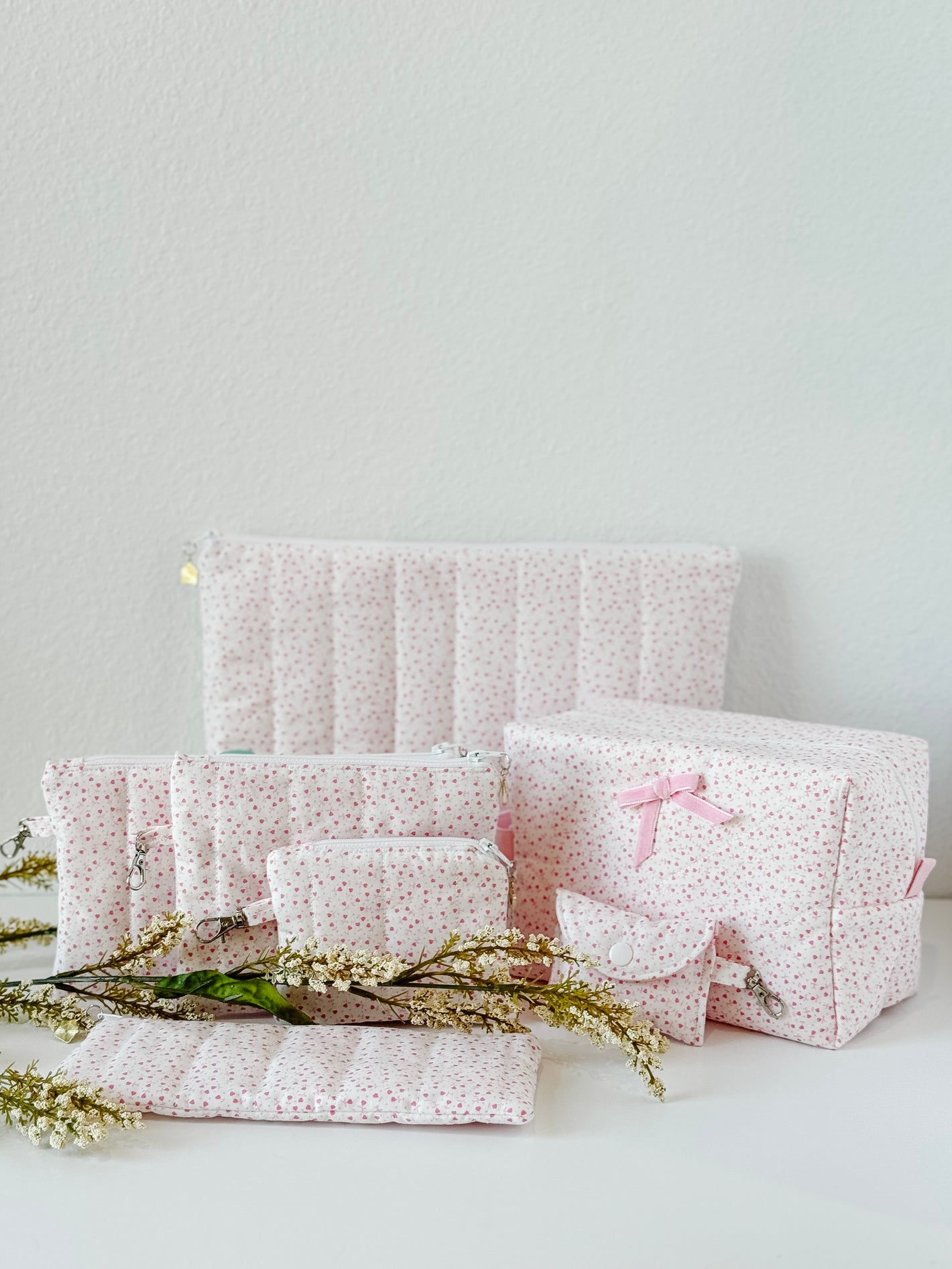 Handmade rosebud quilted cosmetic and pouch collection with pink interiors
