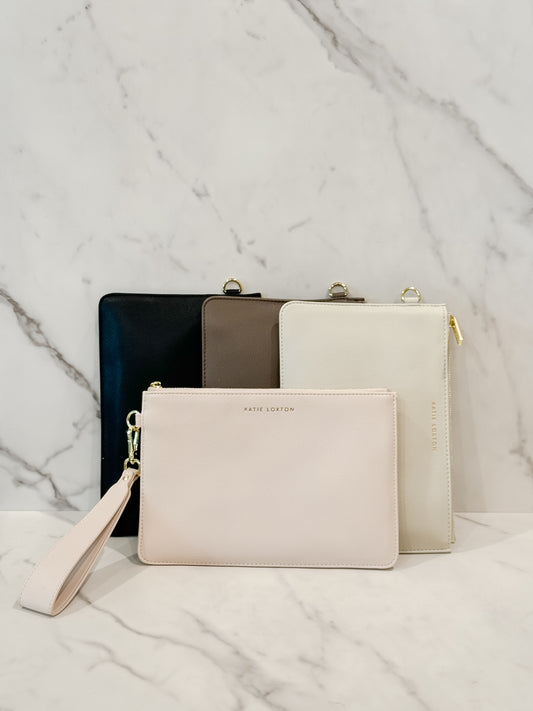 ZANA Wristlet Pouches in four colors - mink, off-white, eggshell, and black - displayed together to showcase the available variety.