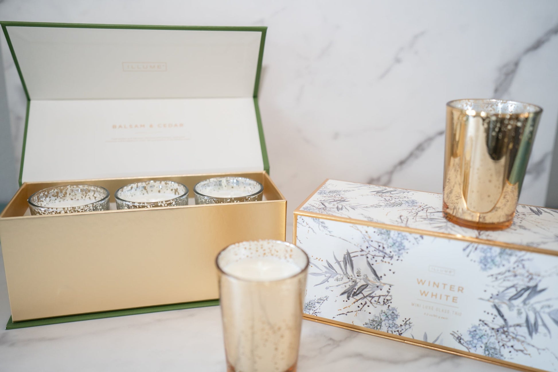 Illume candle gift set featuring evergreen, citrus, and white peppercorn notes