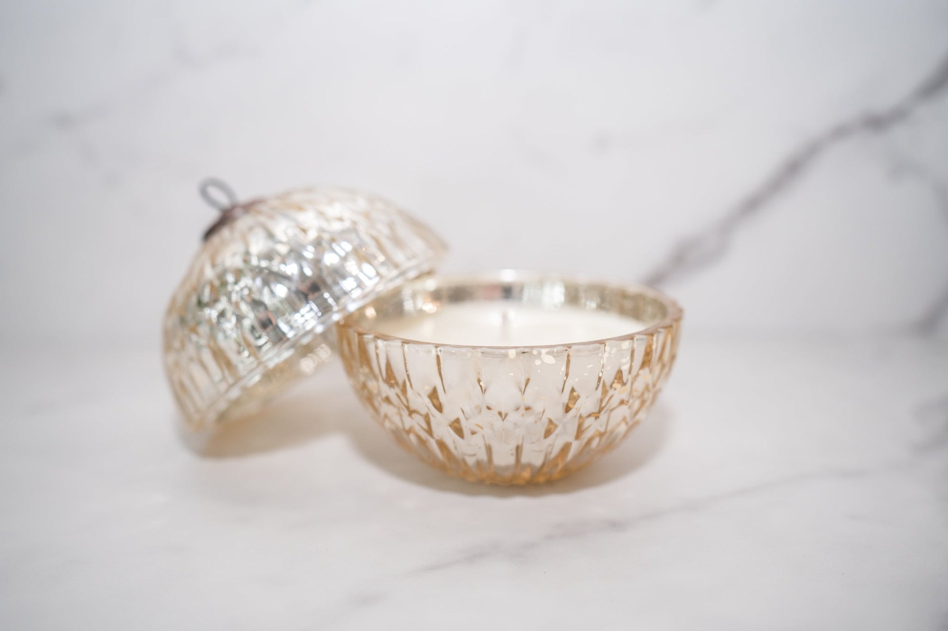 Illume Winter White Mercury Ornament Candle in gold mercury glass vessel