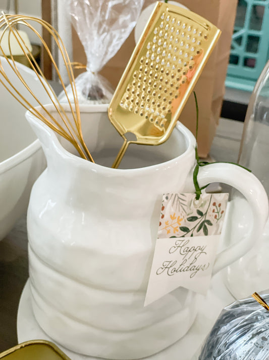 Stoneware pitcher with gold whisk and grater